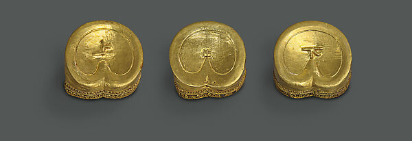 3 gold horse-hoof ingots on display at the Metropolitan Museum of Art
