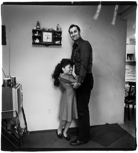 Couple in their living room hugging