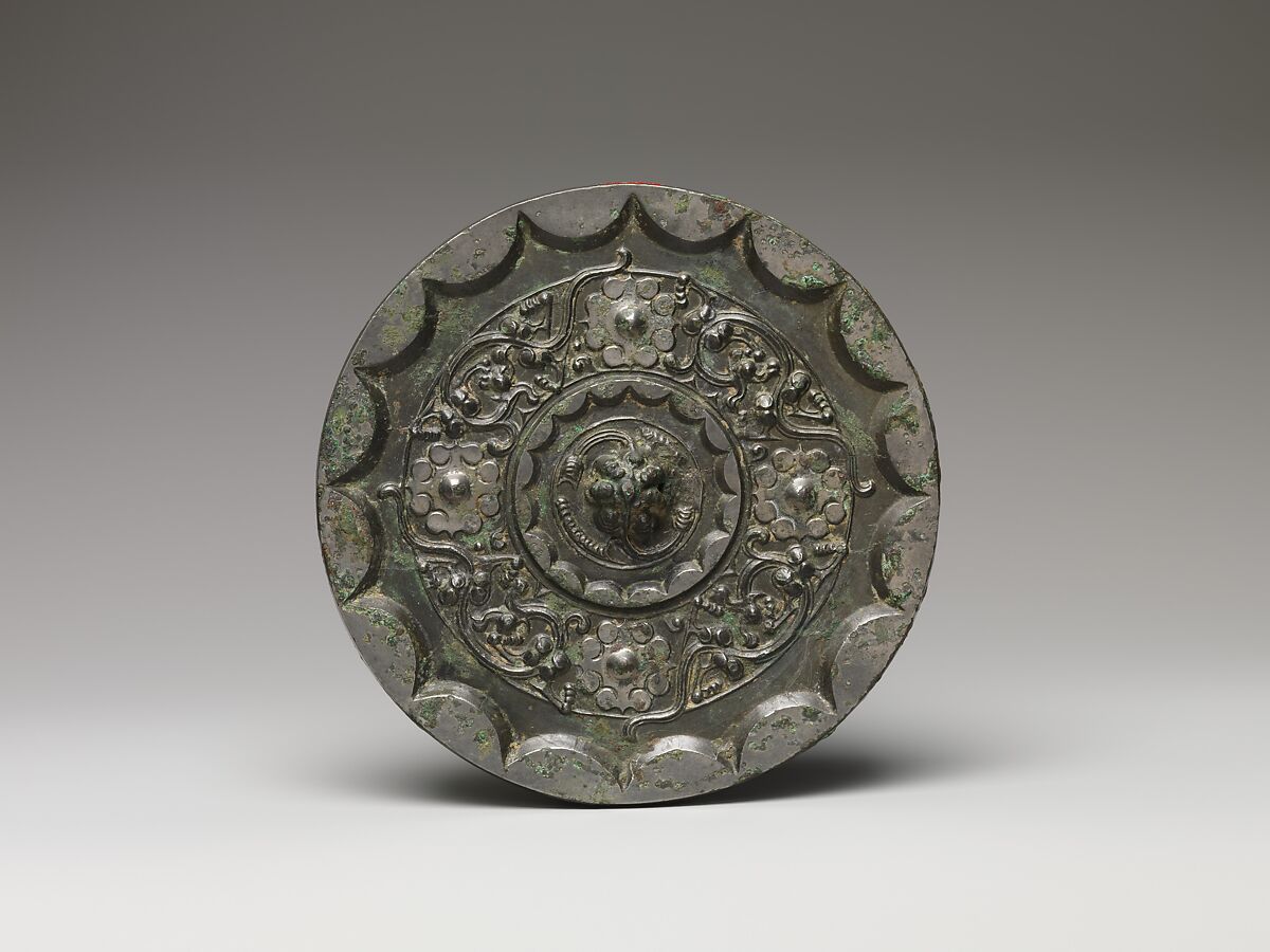 Mirror with dragons and knob-and-swirl design, Bronze, China 