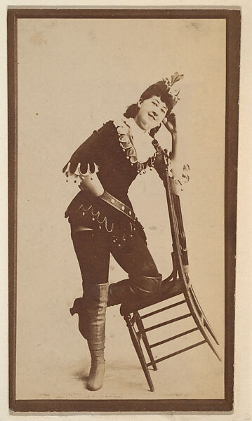 [Actress in costume with left knee on tipped chair], from the Actors and Actresses series (N150b) issued by Duke Sons & Co. to promote Duke Cigarettes, Issued by W. Duke, Sons &amp; Co. (New York and Durham, N.C.), Albumen photograph 
