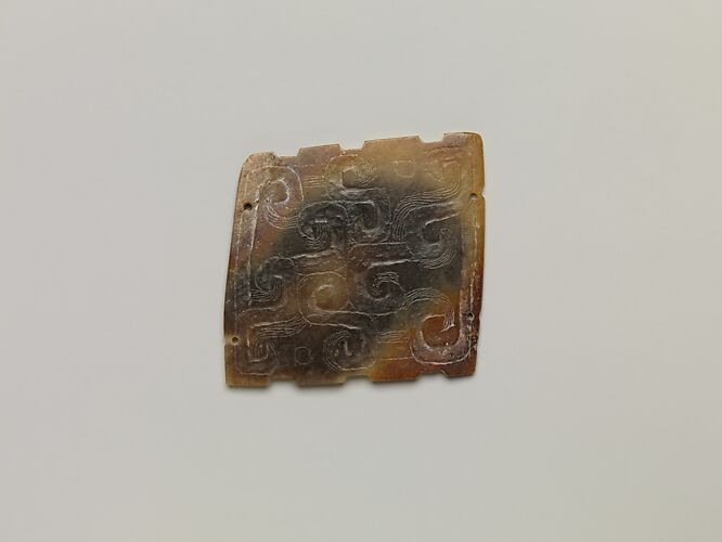 Plaque with incised designs