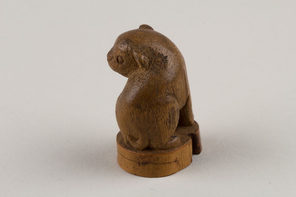 Netsuke: Seal in the Form of a Seated Pug-Dog, Bamboo root, Japan