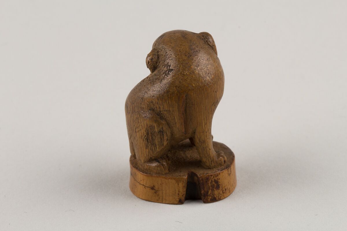Netsuke: Seal in the Form of a Seated Pug-Dog, Bamboo root, Japan