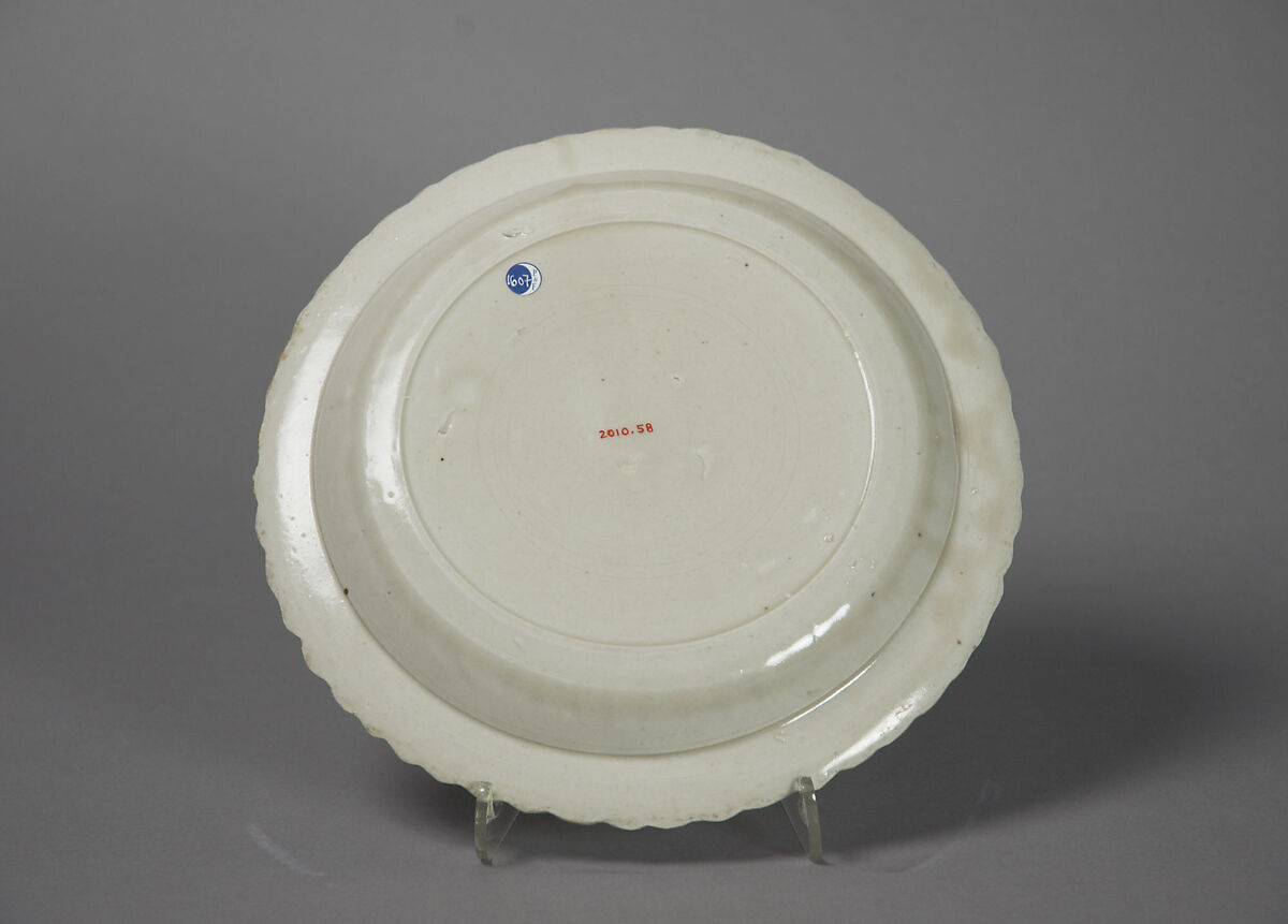 Chrysanthemum-petal dish with tortoise, cranes, and flowers, Porcelain with impressed design under glaze (Ding ware), China