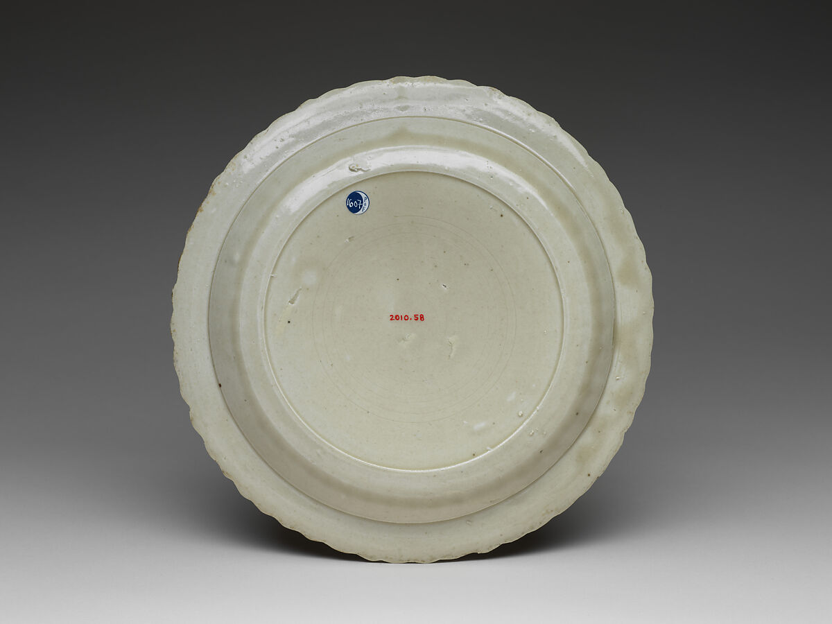 Chrysanthemum-petal dish with tortoise, cranes, and flowers, Porcelain with impressed design under glaze (Ding ware), China