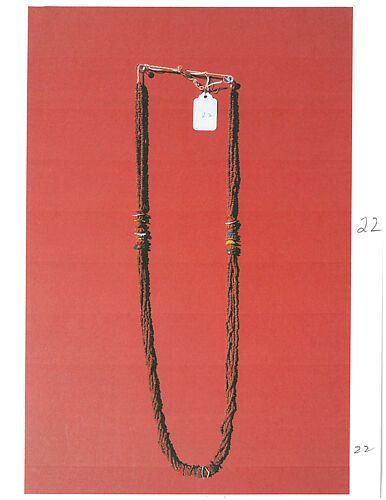Necklace, five strands magenta-colored seeds