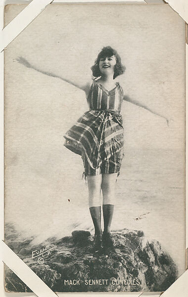 Bathing beauty in costume on rocks with arms outstretched from Mack Sennett Comedies Arcade series (W423), Commercial photolithograph 