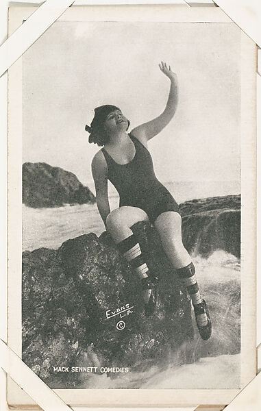 Bathing beauty seated on rocks with arm lifted from Mack Sennett Comedies Arcade series (W423), Commercial photolithograph 