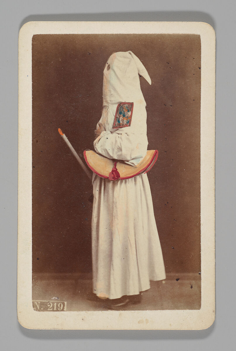 [Studio Portrait: Person Wearing White Robe and Face Covering Hood, Naples], Giorgio Conrad (Italian (born Switzerland), 1827–1889), Albumen silver print with applied color 