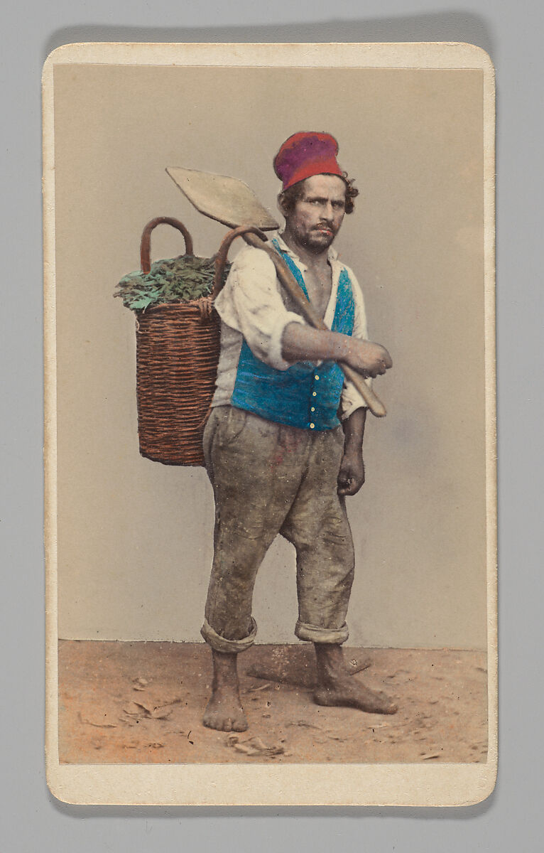 [Studio Portrait: Man Carrying Shovel and Basket of Rags], Unknown (Italian), Albumen silver print with applied color 