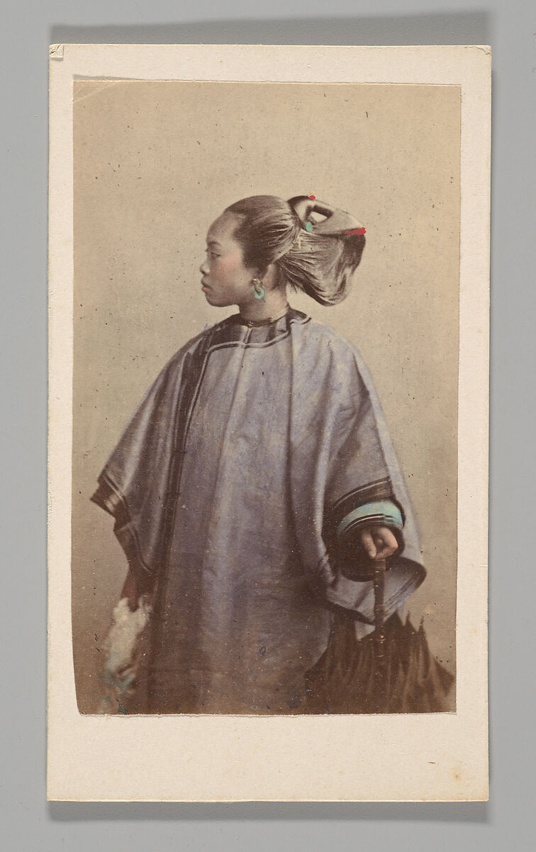 [Studio Portrait: Woman Standing in Profile Holding Umbrella, Hong Kong], Unknown, Albumen silver print with applied color 