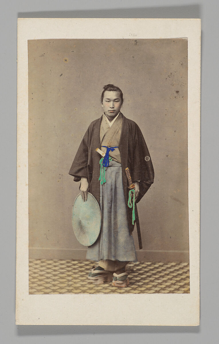 [Japanese Naval Officer]
[Studio Portrait: Japanese Man (Tateise Onogero) Standing Holding Hat and Sword], Attributed to Felice Beato (British (born Italy), Venice 1832–1909 Luxor), Albumen silver print with applied color 
