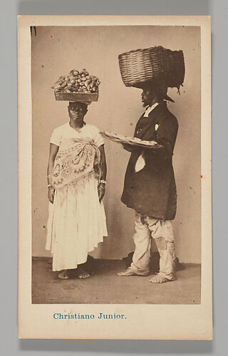 [Studio Portrait: Female and Male Street Vendors with Baskets on Head, Brazil]