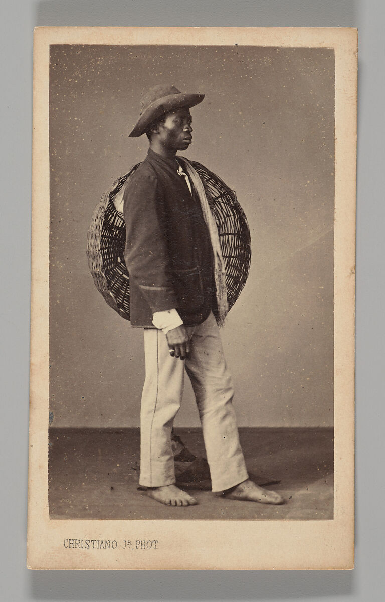 [Studio Portrait: Male Street Vendor Standing in Profile Holding Basket, Brazil], Christiano Junior (Portuguese, active Argentina, 1832–1902), Albumen silver print 