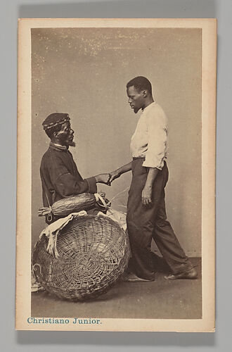 [Studio Portrait: Two Male Street Vendors in Profile, one Seated one Standing, Shaking Hands, Brazil]