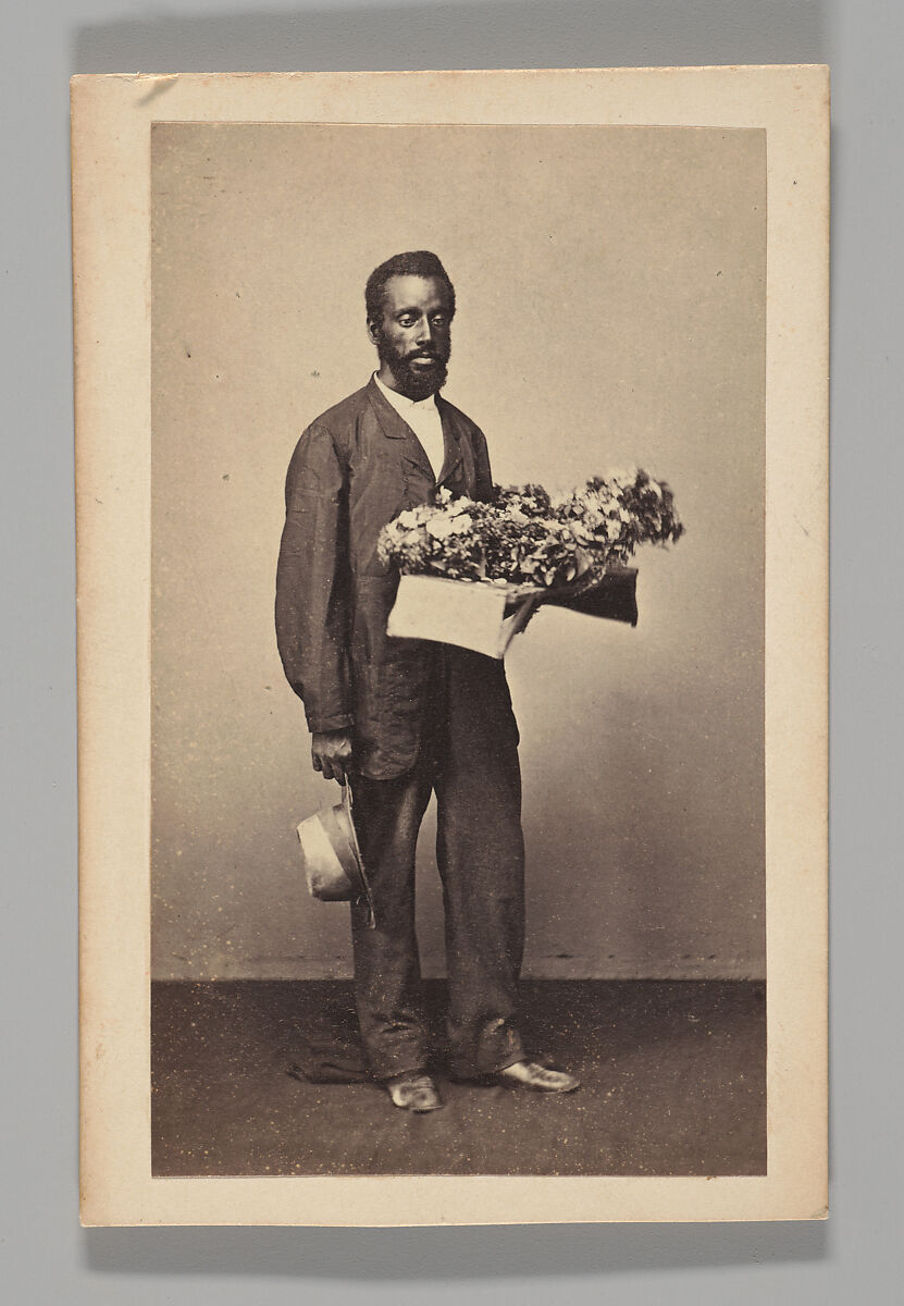 [Studio Portrait: Male Street Vendor Holding Box of Flowers, Brazil], Unknown, Albumen silver print 