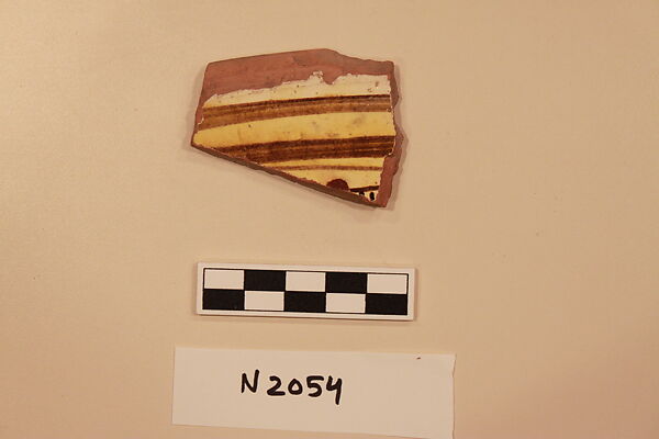 Ceramic Fragment, Earthenware; white slipped, slip-painted under a yellow glaze 