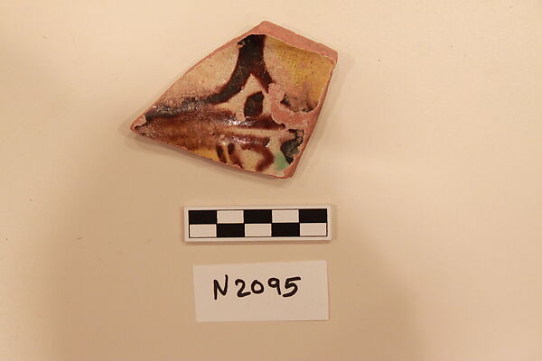 Ceramic Fragment, Earthenware; white slipped, in glaze painted in brown, yellow and green 