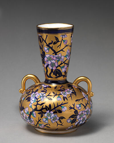 Vase with branch of white blossom (one of a pair)