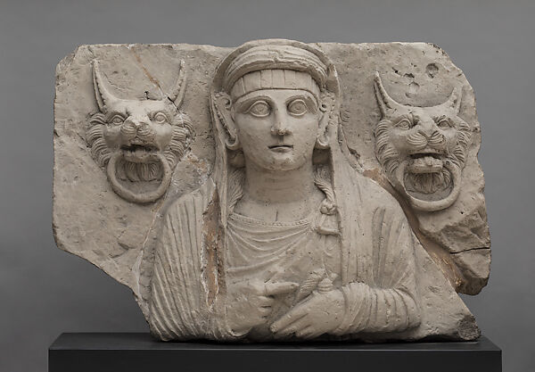 Portrait of a woman holding a spindle and distaff and flanked by lion handles, Limestone 