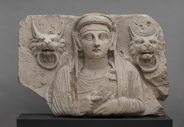 Portrait of a woman holding a spindle and distaff and flanked by lion handles, Limestone