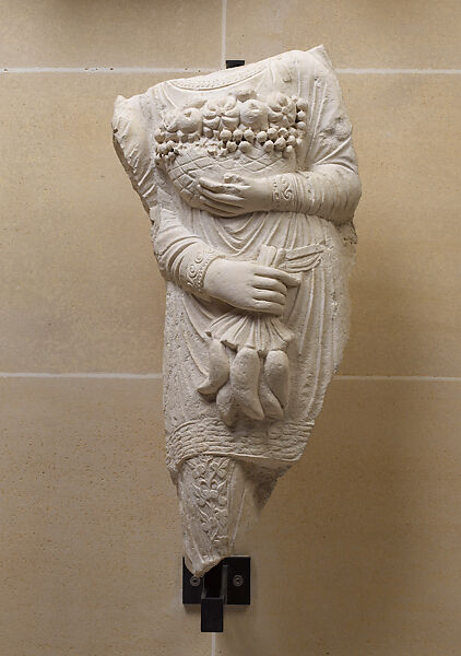 Relief with banquet attendant carrying fruits and vegetables, Limestone 