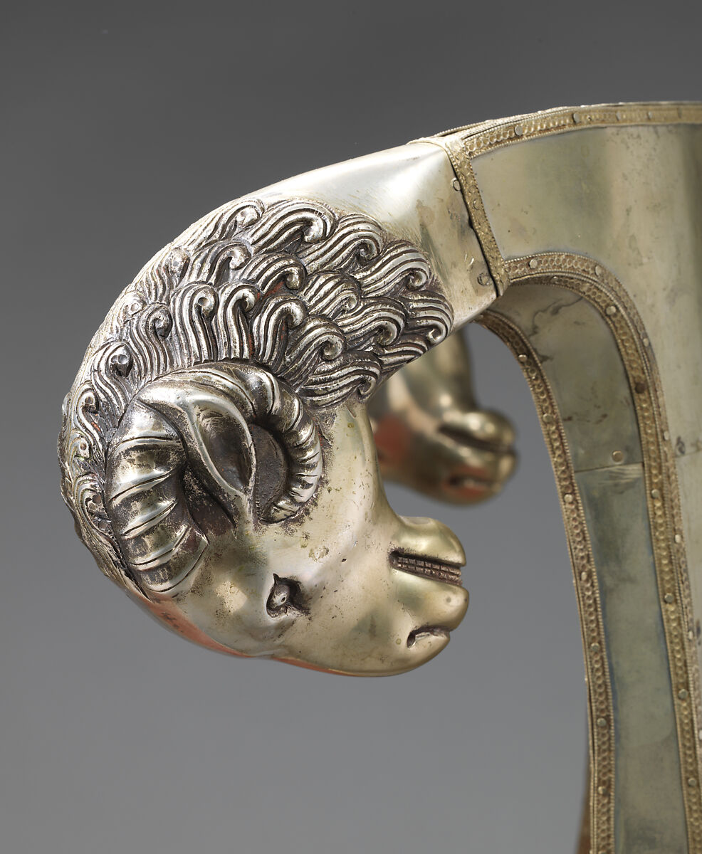 Side chair with rams' heads (one of a pair), White alloy metal sheets (silvered?) over wooden core, probably teak; silk and metallic woven textile, Anglo-Indian