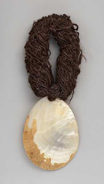 Engraved pearl shell with human hair string, Carved Australian Gold-Lipped Pearl Shell, Pinctada Maxima [not endangered], natural earth pigments, human hair, Western Australia