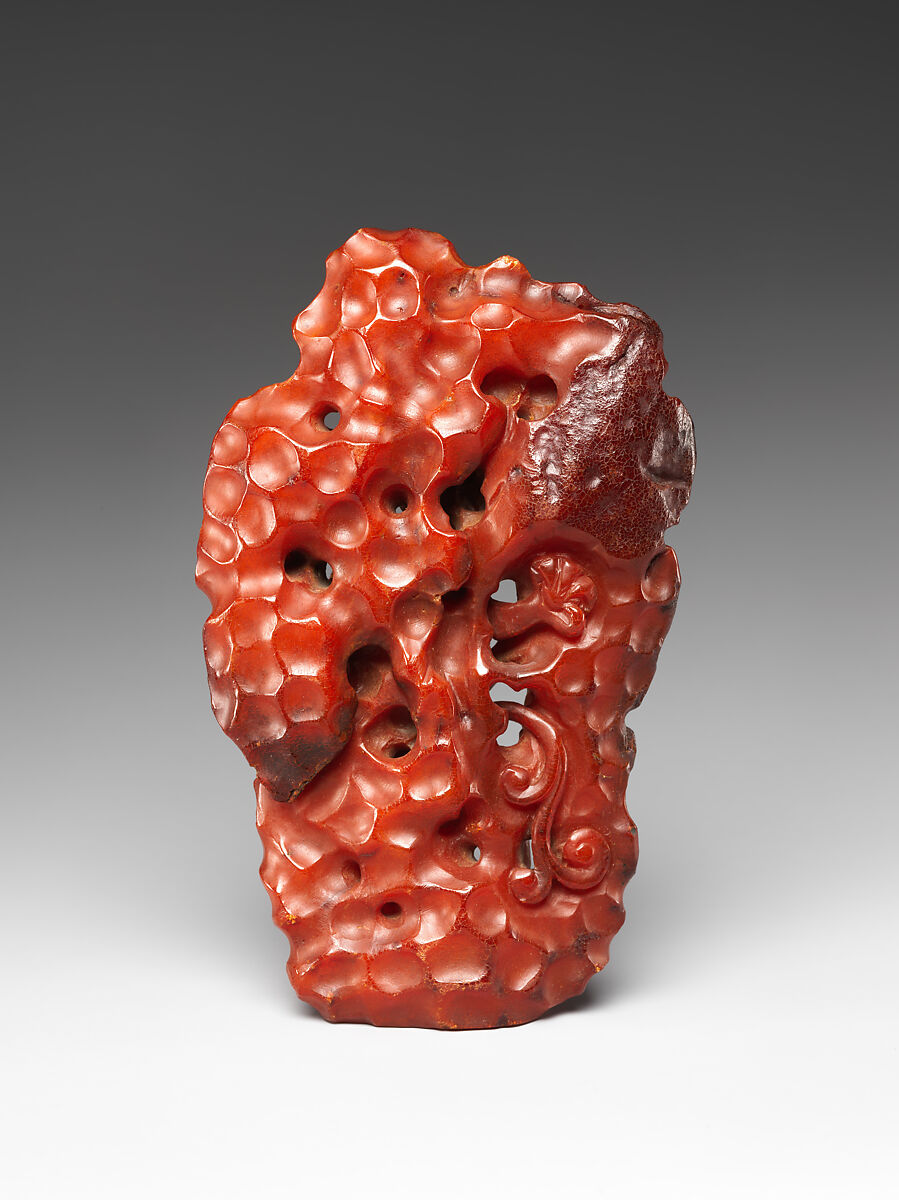 Dragon climbing a rock, Amber, China