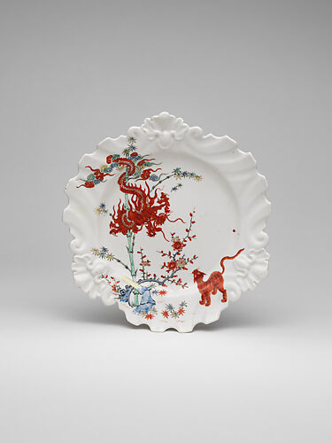 Plate decorated with Japanese Kakiemon-inspired scene with twisted dragon