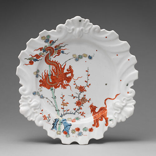 Plate decorated with Japanese Kakiemon-inspired scene with twisted dragon