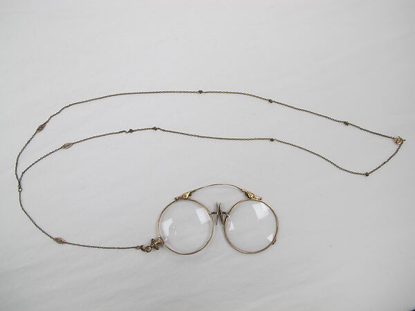 Eyeglasses, (a) gold, glass (b) metal, (c) leather , American