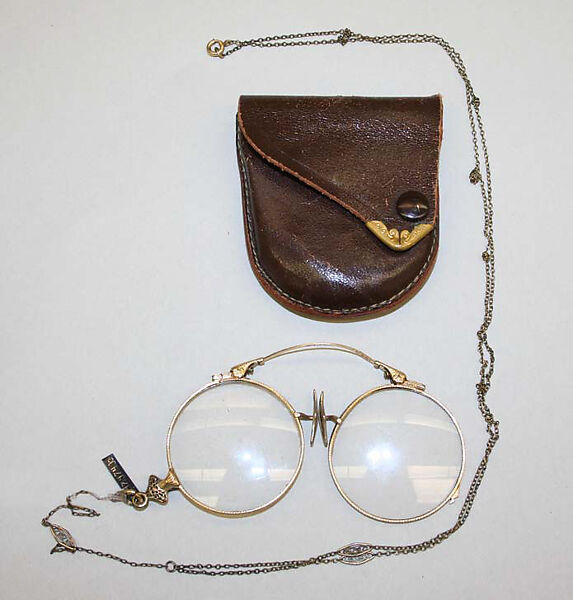 Eyeglasses, (a) gold, glass (b) metal, (c) leather , American 