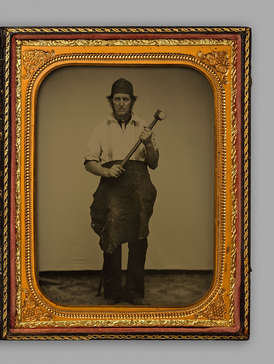 [Man Gripping Sledgehammer, Wearing Leather Half Apron and Cap], Unknown, Ambrotype with applied color