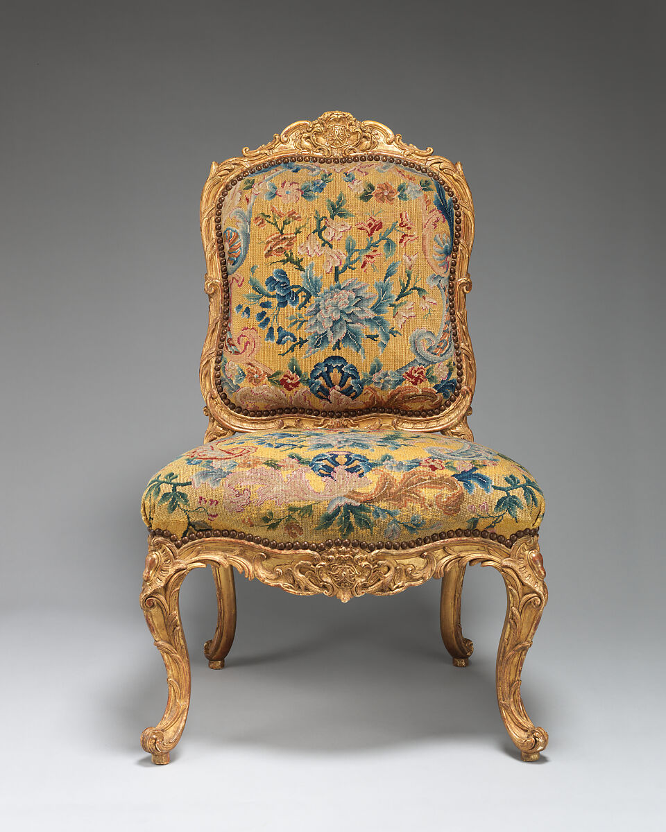 Chair (chaise à la Reine) (one of a set of four), Probably by Jean-Baptiste I Tilliard (French, 1686–1766), Beechwood unusually richly carved and gilded; previously upholstered with coral colored velvet attached with brass-headed nails, now upholstered in yellow petit point, French, Paris