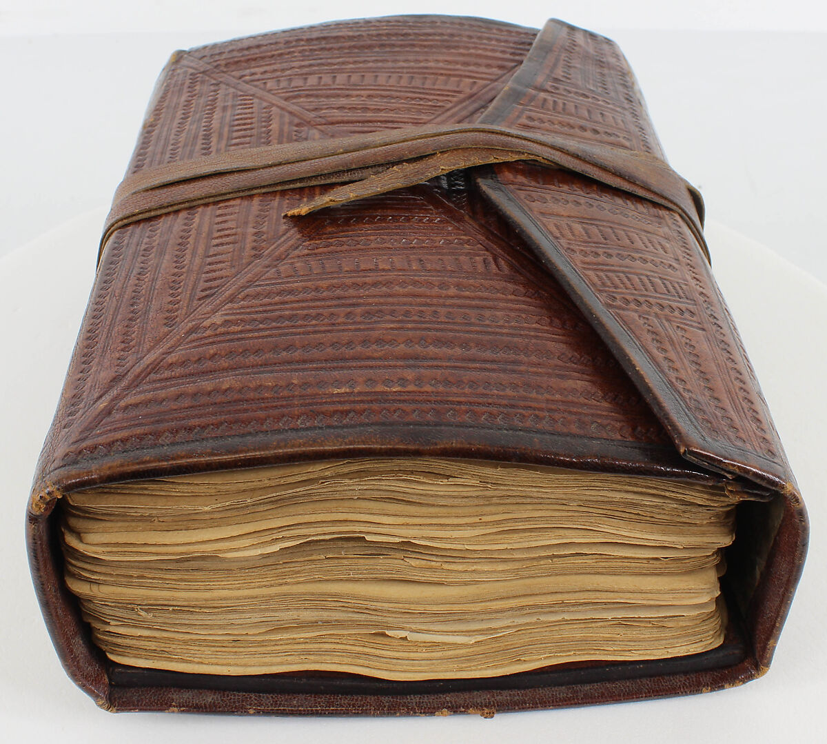 Qur'an, Ink and opaque watercolor on paper; embossed leather cover