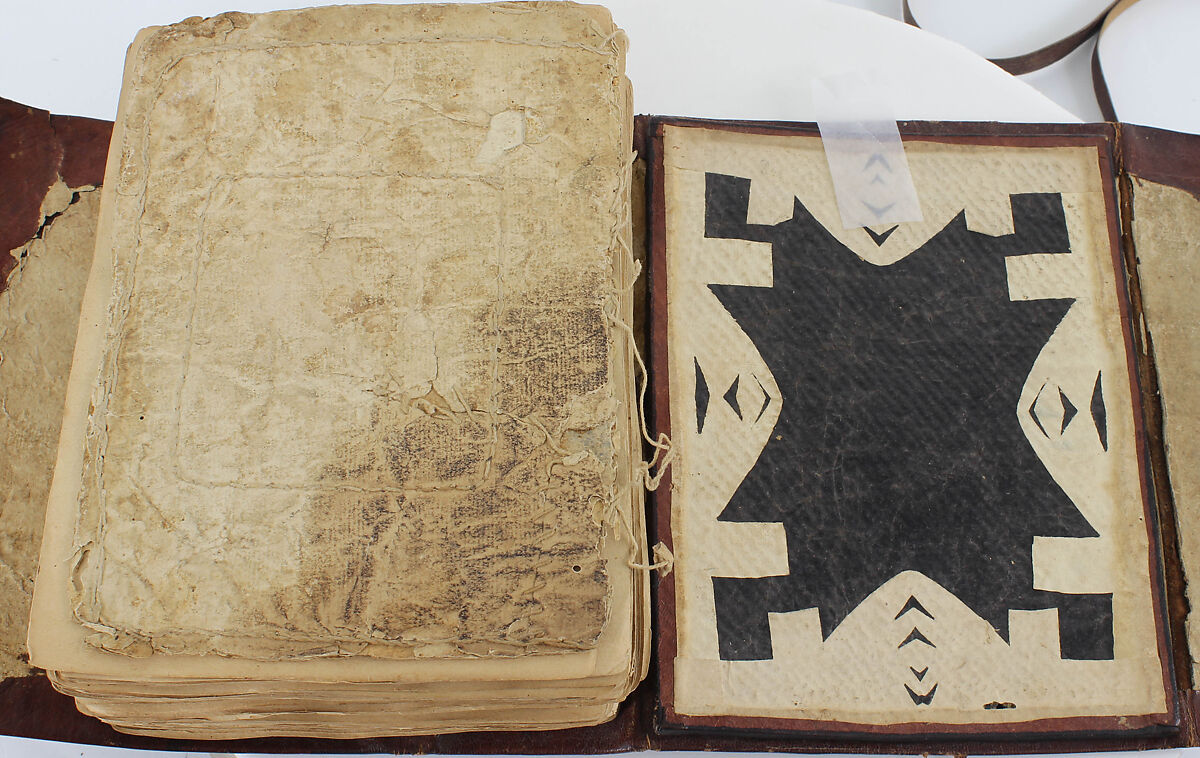 Qur'an, Ink and opaque watercolor on paper; embossed leather cover