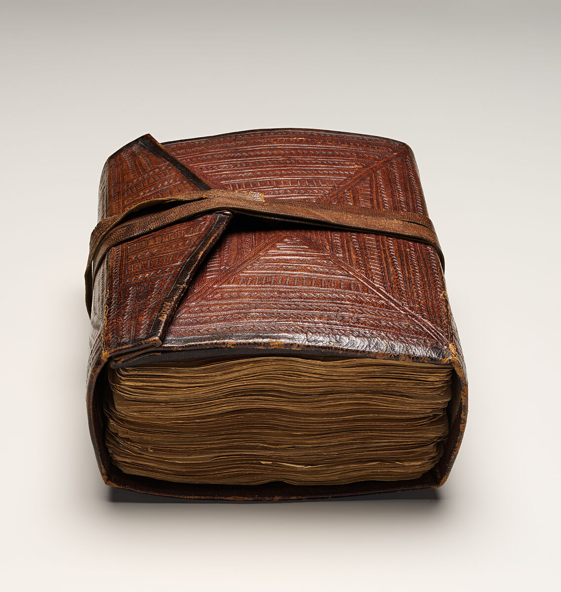 Qur'an, Ink and opaque watercolor on paper; embossed leather cover