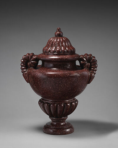 Urn with ram's horn handles and gadrooned lid and socle (one of a pair)