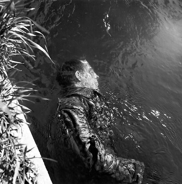 Dead SS Prison Guard Floating in Canal, Dachau, Germany, Lee Miller (American, 1907–1977), gelatin silver print 