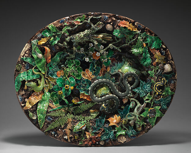 Large basin with snake, ferns, and bark