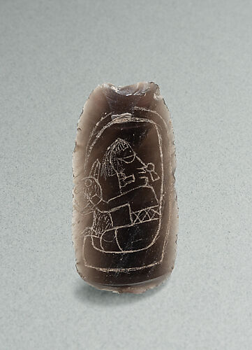 Incised flake with deity image
