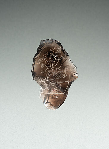 Incised flake with deity image
