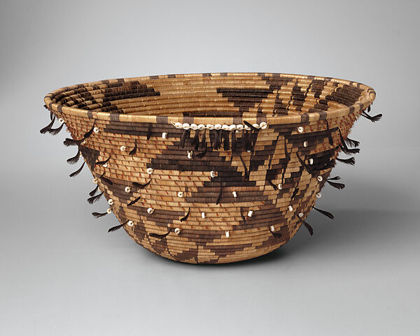 Three-rod coiled ceremonial washing basket, Willow shoot foundation, sedge root weft, dyed bulrush root weft, feathers (acorn woodpecker, California valley quail topknots), clamshell, and cotton string, Pomo (Northern California)