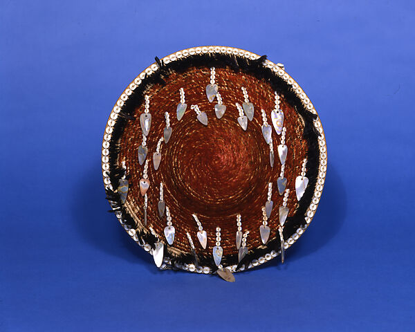 Red fully feathered three-rod coiled ceremonial plaque with handle, Mary Posh  Big Valley Pomo and Elem Pomo (Lake County, California), Willow shoot foundation, sedge root weft, feathers (California valley quail topknots, acorn woodpecker), clamshell, abalone, and commercial string, Big Valley Pomo and Elem Pomo (Lake County, California)