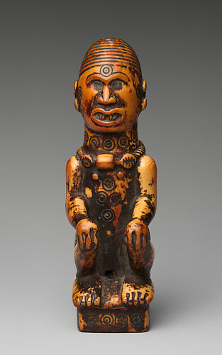 Staff finial with seated woman