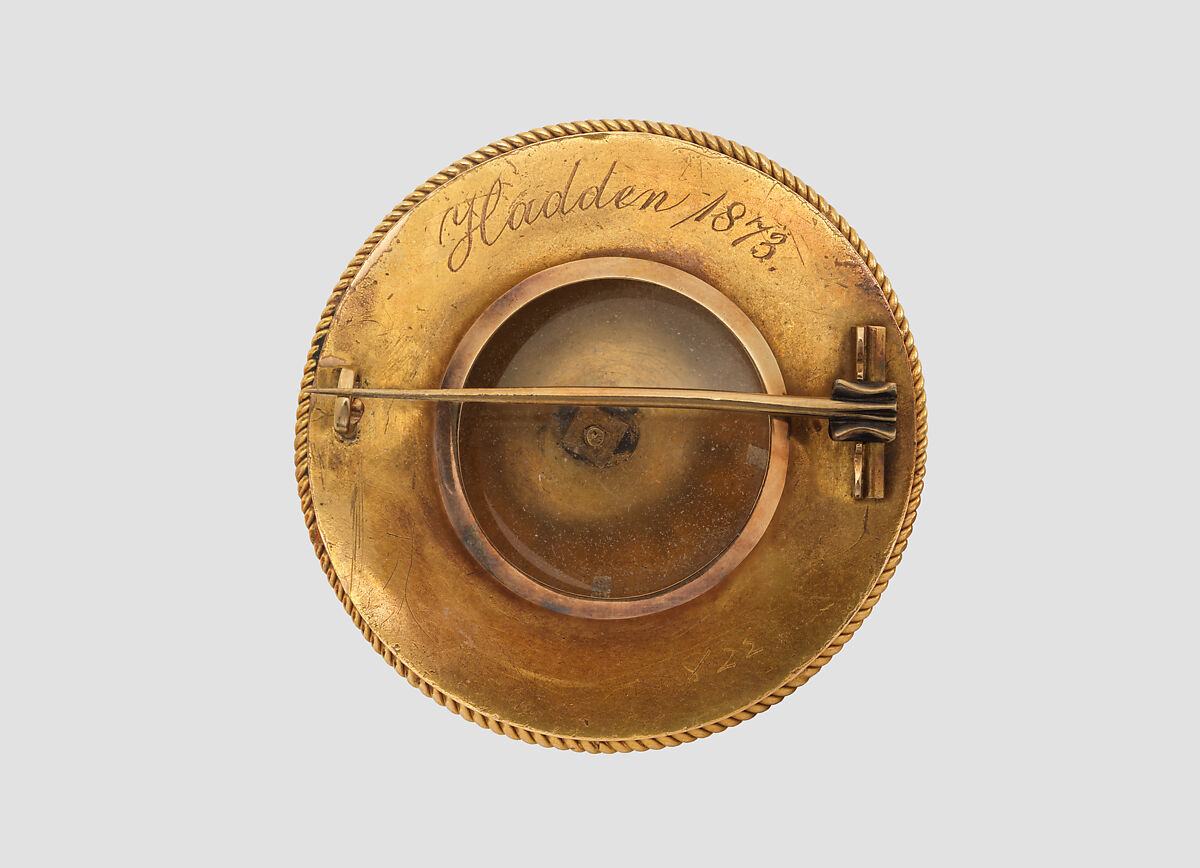 Brooch with Assyrian human-headed winged bull, Gold, enamel, glass, British