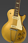 Les Paul Model Electric Guitar and Amplifier, Gibson (American, founded Kalamazoo, Michigan 1902), Neck/Head: Honduran Mahogany; Headstock Veneer: Painted holly; Headstock Decoration: Mother of Pearl; Truss Rod Cover: Plastic; Tuning Machines: Metal; Machine Head Buttons: Plastic; Nut: Bone?; Fingerboard: Brazilian Rosewood; Fret markers: Mother of Pearl; Frets: Nickel silver; Strings: Metal; FB Binding: Plastic; Pick up covers: Plastic; Vol/Tone knobs: Plastic; Soundboard/Top: Honduran Mahogany; Solid Body: Honduran Mahogany 
Binding: Plastic; 
Pickguard: Plastic; Bridge: Metal; Neck side strap button: Metal 
End strap button: Metal; Tailpiece: Metal, American