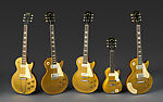 Les Paul Model Electric Guitar and Amplifier, Gibson (American, founded Kalamazoo, Michigan 1902), Neck/Head: Honduran Mahogany; Headstock Veneer: Painted holly; Headstock Decoration: Mother of Pearl; Truss Rod Cover: Plastic; Tuning Machines: Metal; Machine Head Buttons: Plastic; Nut: Bone?; Fingerboard: Brazilian Rosewood; Fret markers: Mother of Pearl; Frets: Nickel silver; Strings: Metal; FB Binding: Plastic; Pick up covers: Plastic; Vol/Tone knobs: Plastic; Soundboard/Top: Honduran Mahogany; Solid Body: Honduran Mahogany 
Binding: Plastic; 
Pickguard: Plastic; Bridge: Metal; Neck side strap button: Metal 
End strap button: Metal; Tailpiece: Metal, American