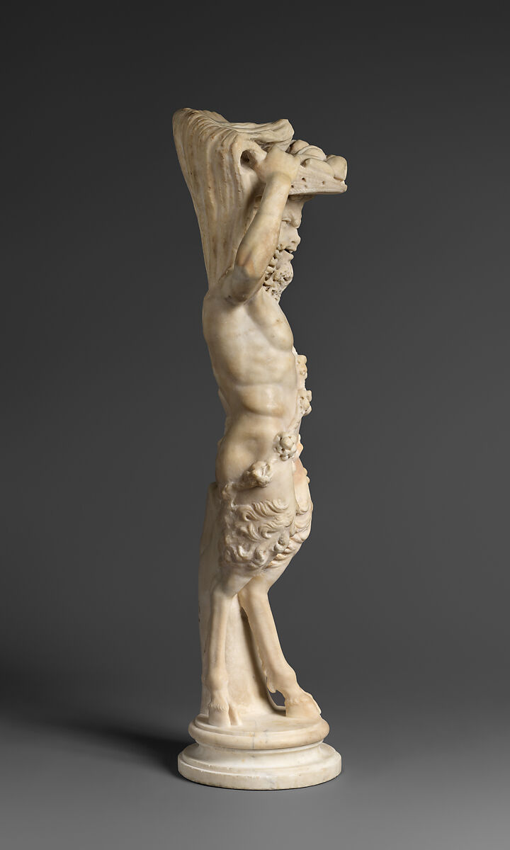 Marble statue of Pan/ Pan or Satyr with winnowing basket filled with offerings and cultic objects, Marble